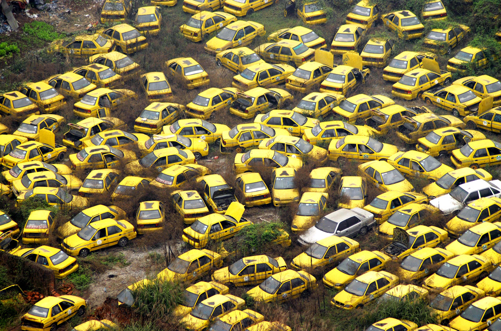 Thousands of scrapped taxis are abandoned at a yard in the center of 