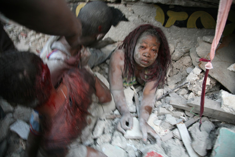 Earthquake Haiti Children. A Haitian woman is covered in
