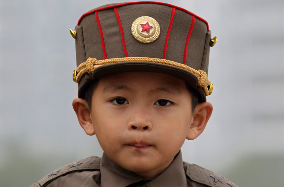 the north korean army. A boy wears a North Korean