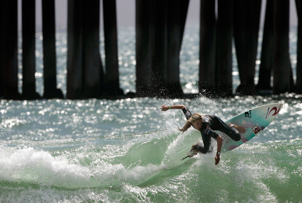 Justine Dupont of France, carves into a wave during the U.S. Open of Surfing on Monday, Aug. 2, 2010, in Huntington Beach, California. (AP Photo/Adam Lau)